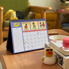 Calendar on a table in a living room with decor elements
