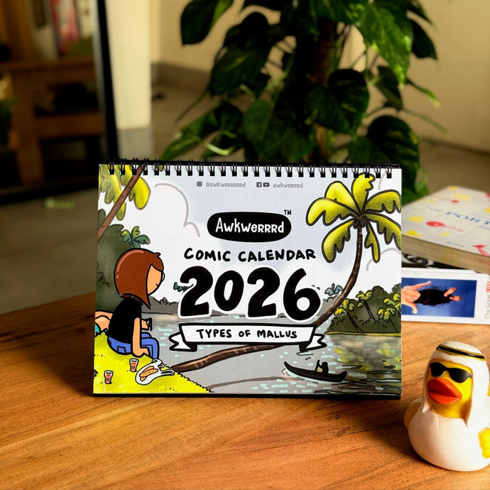 Comic calendar for 2026 on a table with a plant in the background