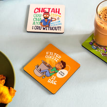 Set of colorful coasters with humorous designs on a table.