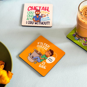 Set of colorful coasters with humorous designs on a table.