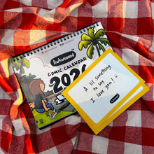 Notebook and card on a red and white checkered fabric