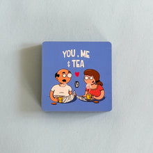 Square blue magnet with cartoon characters and text 'You, Me & Tea' on a light gray background