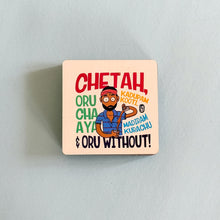 Square wooden coaster with colorful design and text on a light gray background