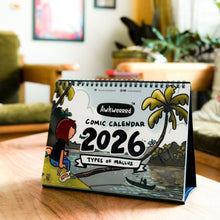 Comic-themed calendar for 2026 on a table in a living room setting